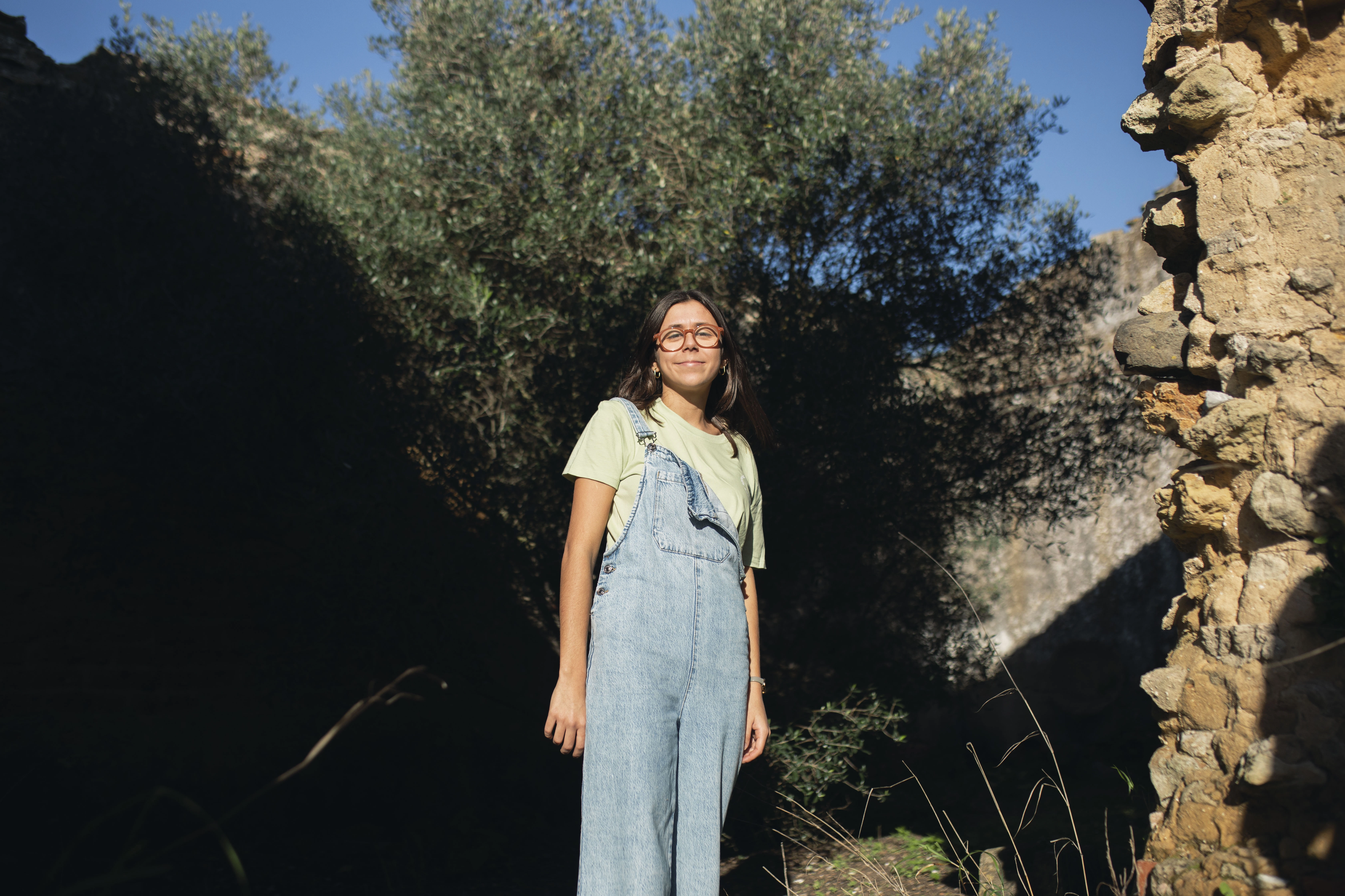 Woman standing by tree